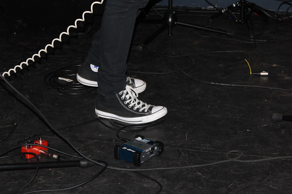 person standing beside white cable