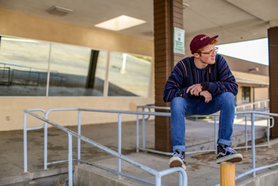 man sitting on railings Empowering young men through mental health retreats