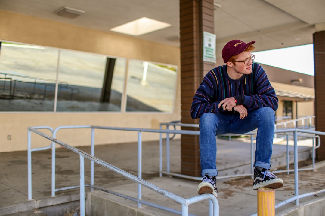 man sitting on railings