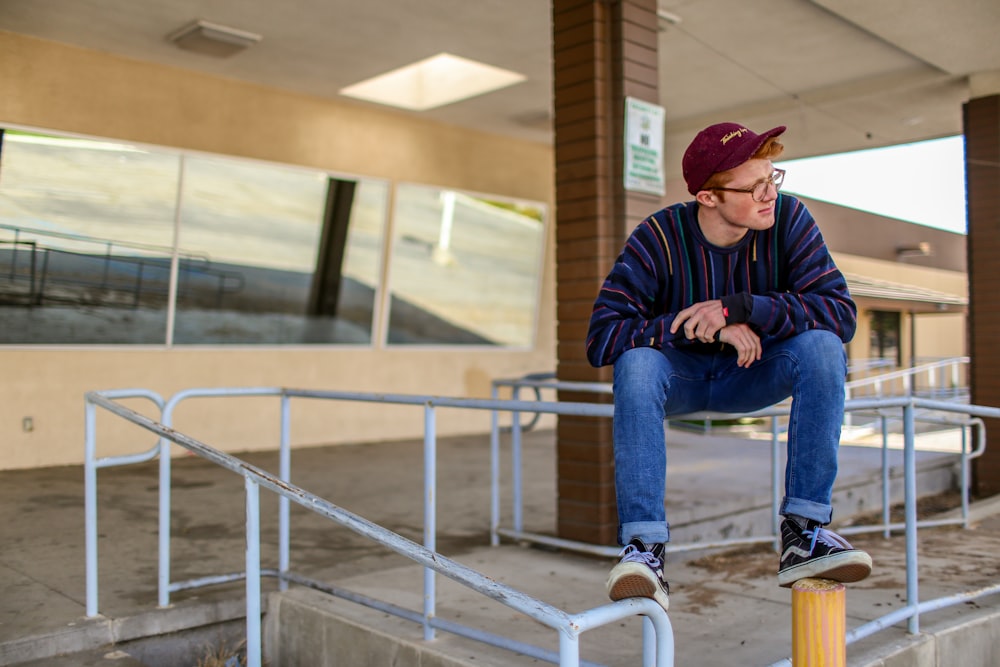 man sitting on railings