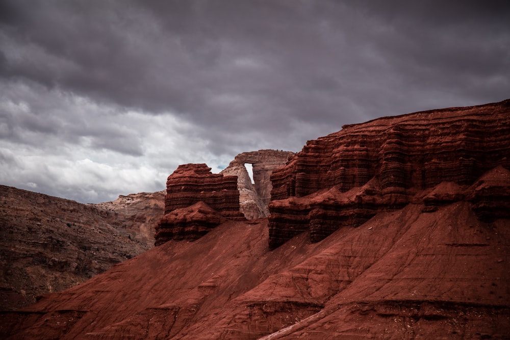 rock formation under cumulus clouds