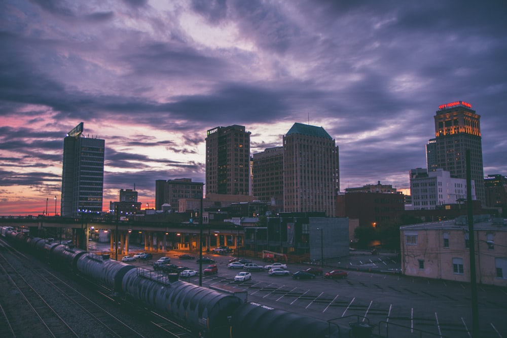 bird's eye view photography of high-rise buildings and train station