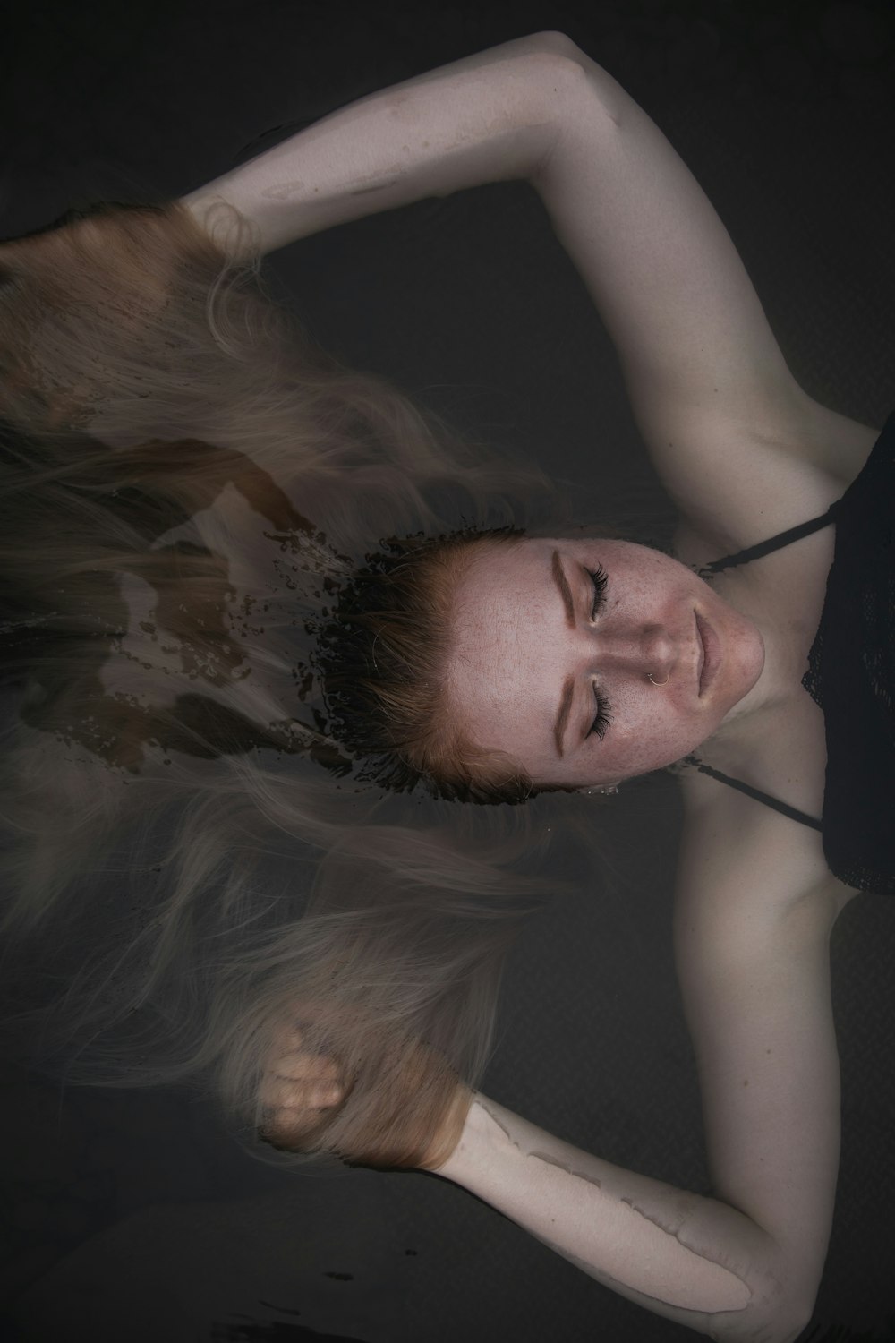 a woman with long hair standing in the water