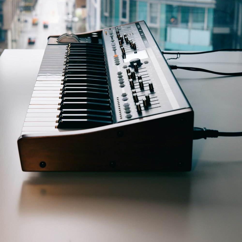 black and white electronic keyboard on table