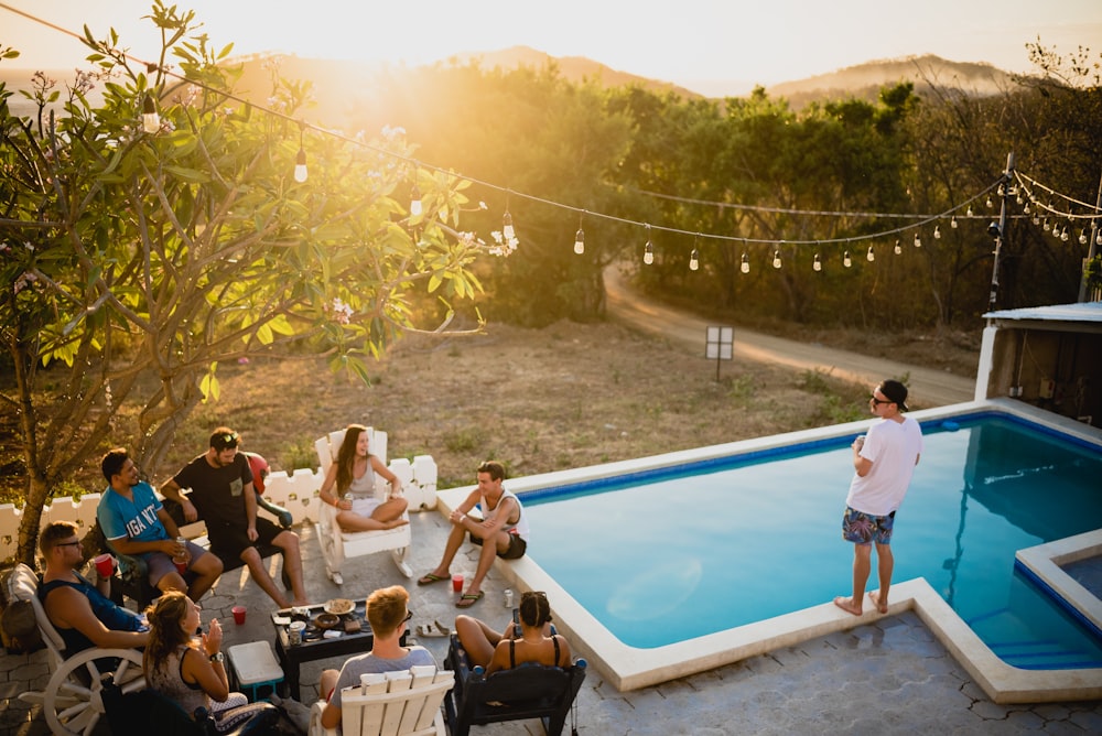 people sitting on chairs near pool