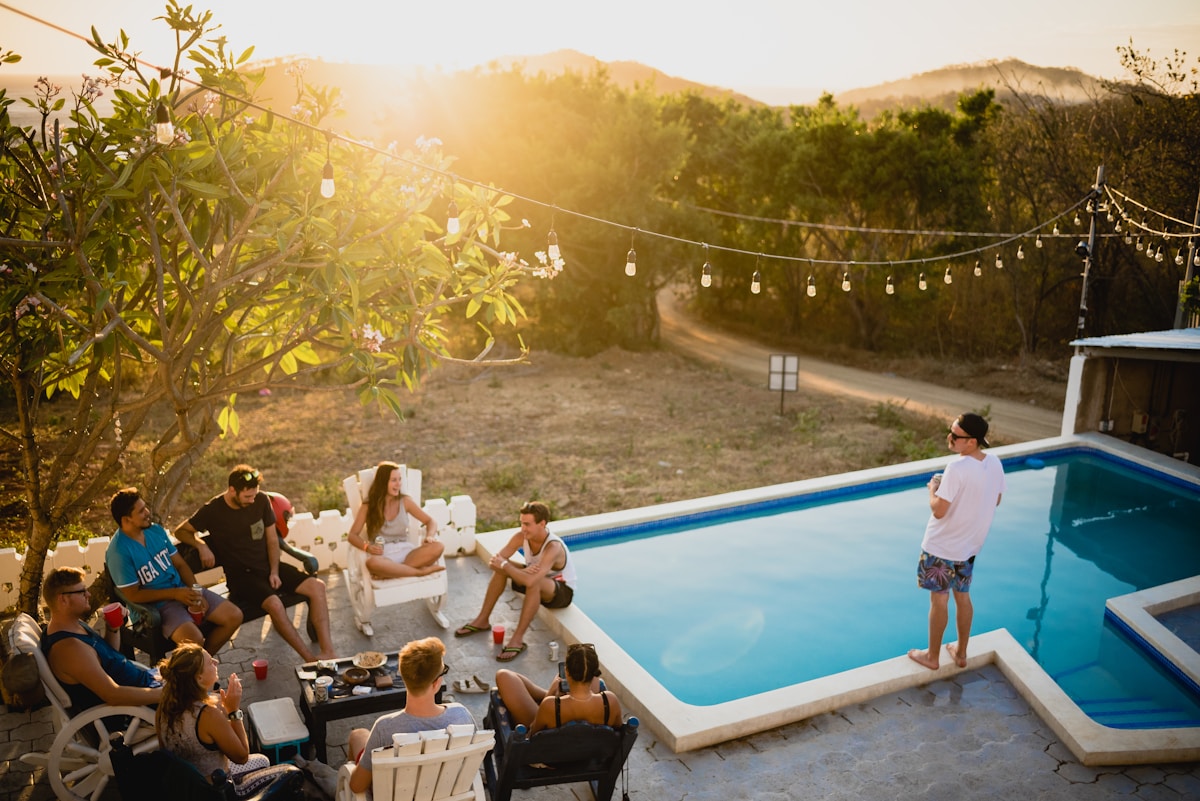 Group of friends by pool at vacation rental