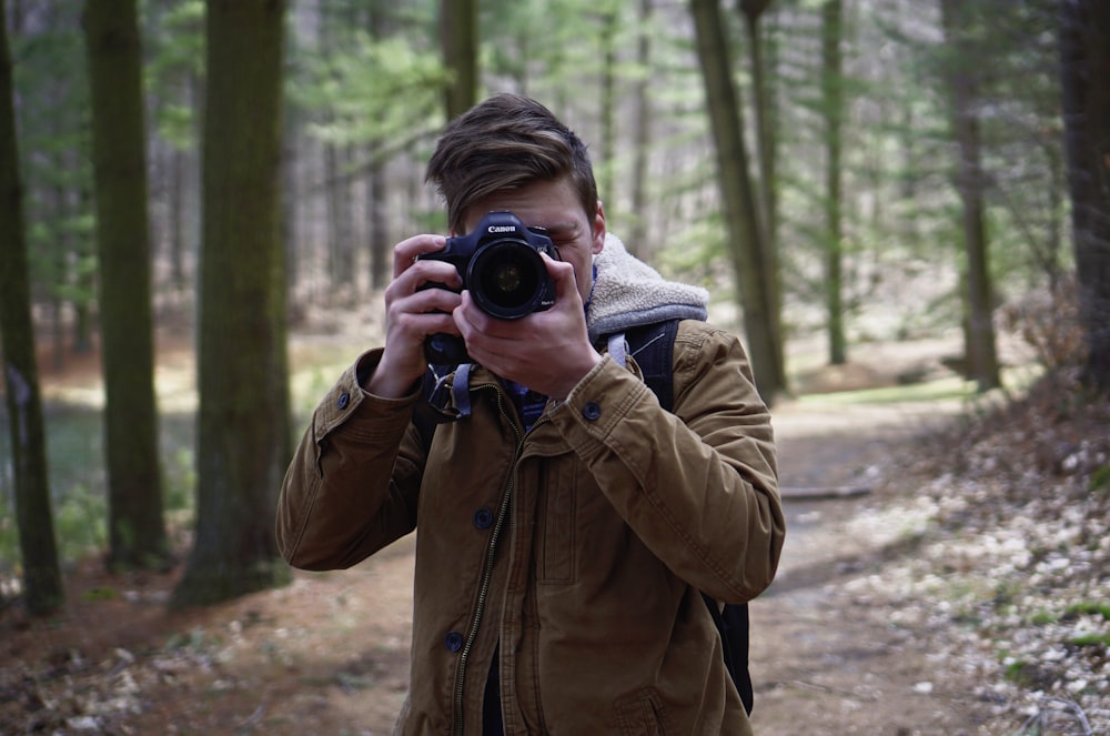 man holding brown coat