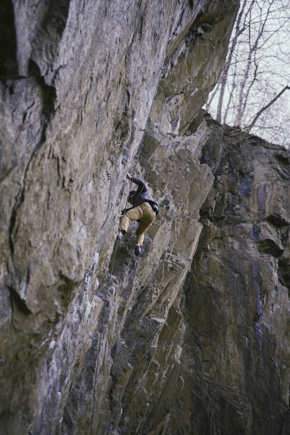 a man climbing up the side of a mountain