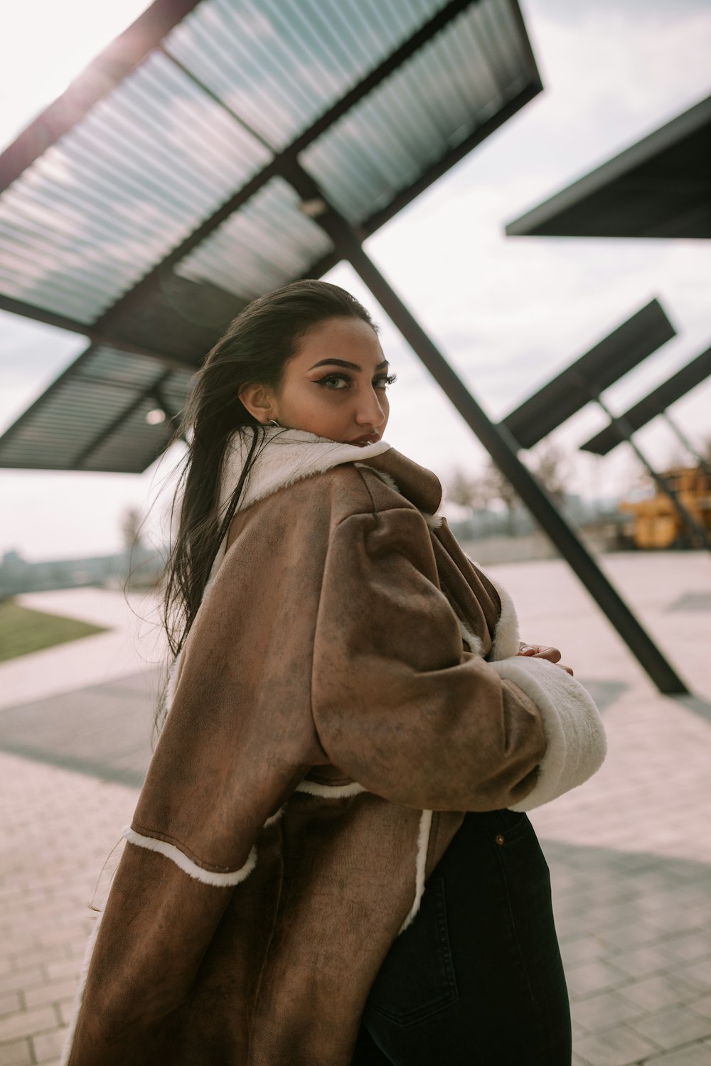 woman in brown coat standing