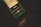 A smartphone lays on a dark surface displaying a music player interface. The screen shows album art and song information, including the title 'sincerely yours' by an artist named No1dea. The interface features music control icons like play, pause, and track progression slider.