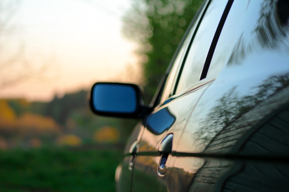 the side view mirror of a car on a road