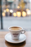 Close-up of a ritorno coffee cup with logo on a wooden table