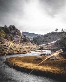 river in the middle of hills