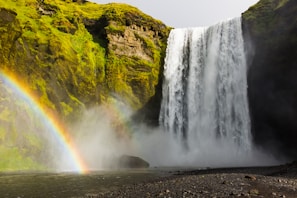 landscape photography of waterfalls and rainbow