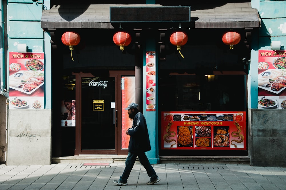 person walking on gray pavement