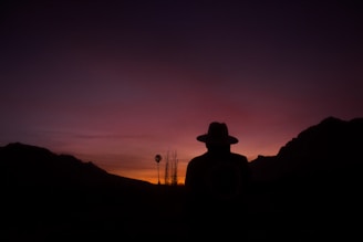 silhouette of man standing on mountain
