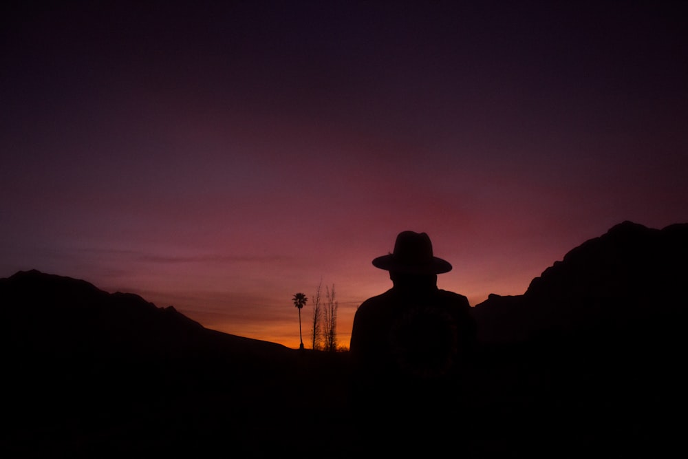 silhouette of man standing on mountain