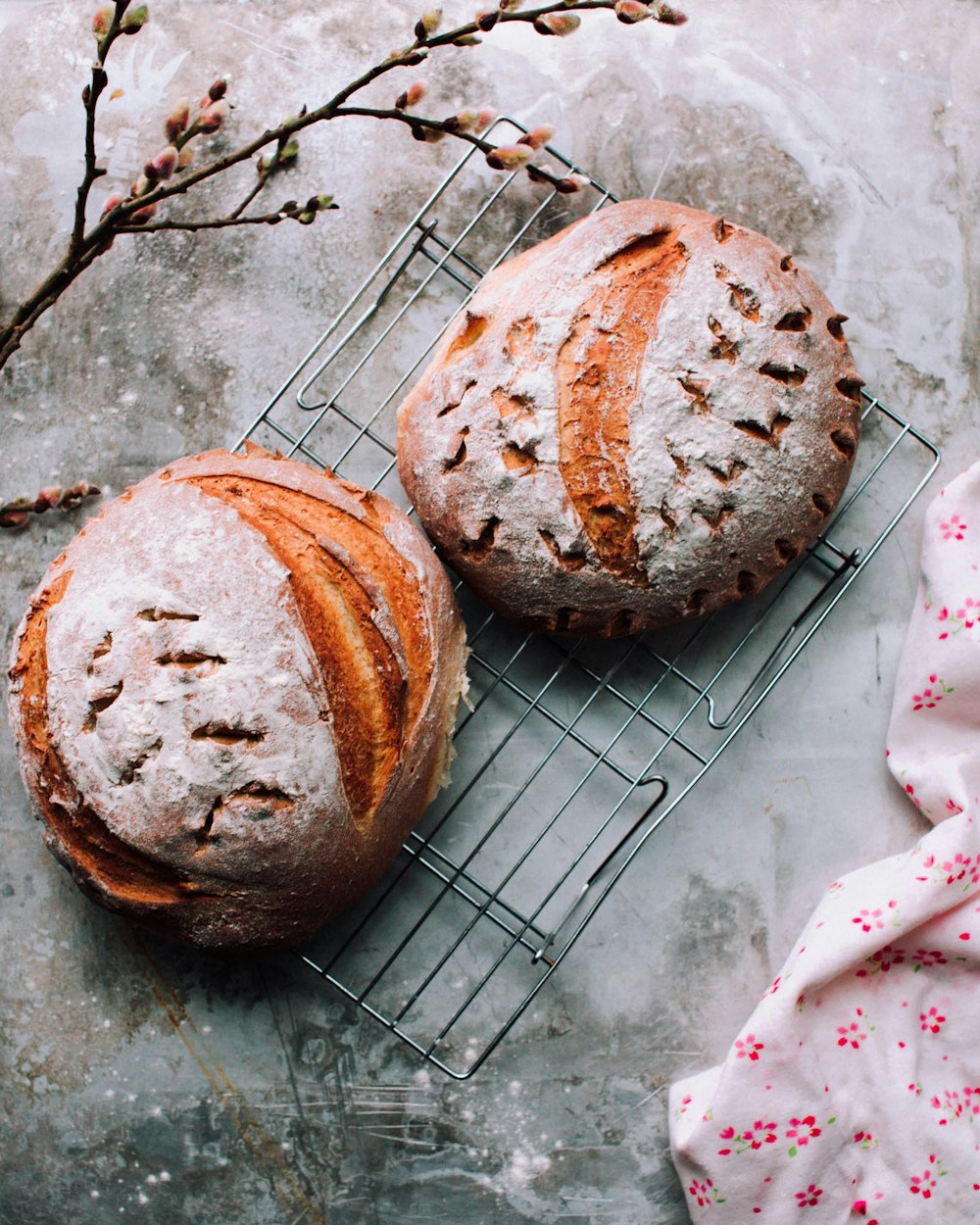 two round brown breads on metal grill