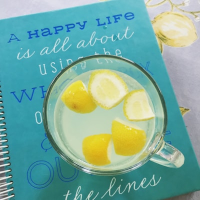 Colorful mugs with silly lemon slice illustrations and cheerful messages.