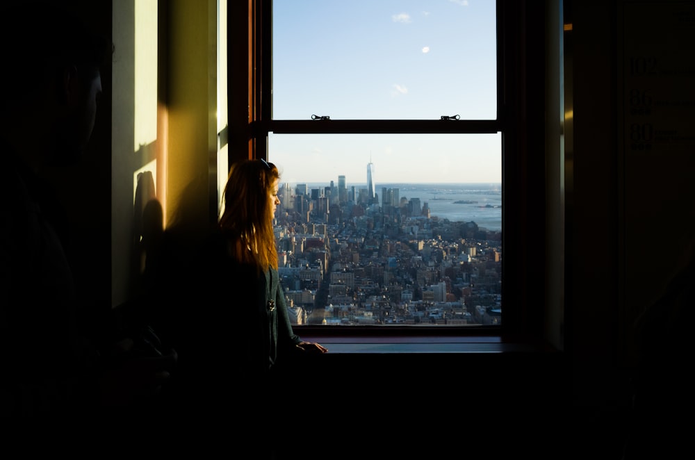 woman standing near window inside room