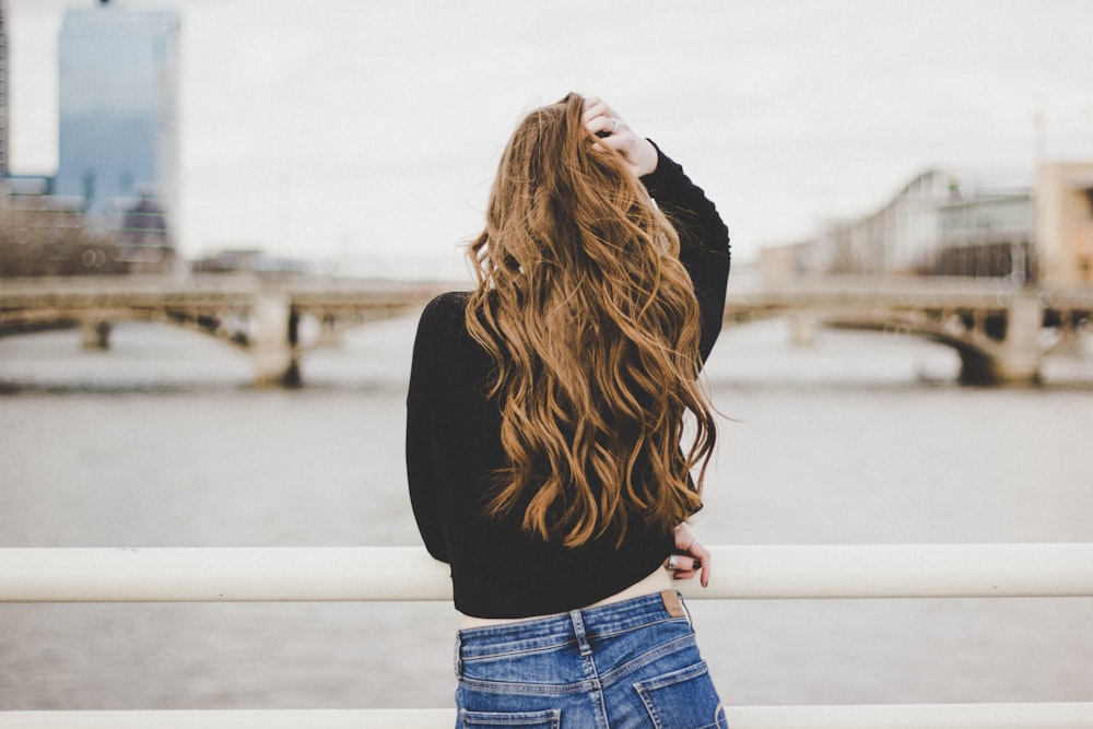 woman standing near white fence