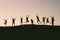 silhouette photo of group of people on mountain