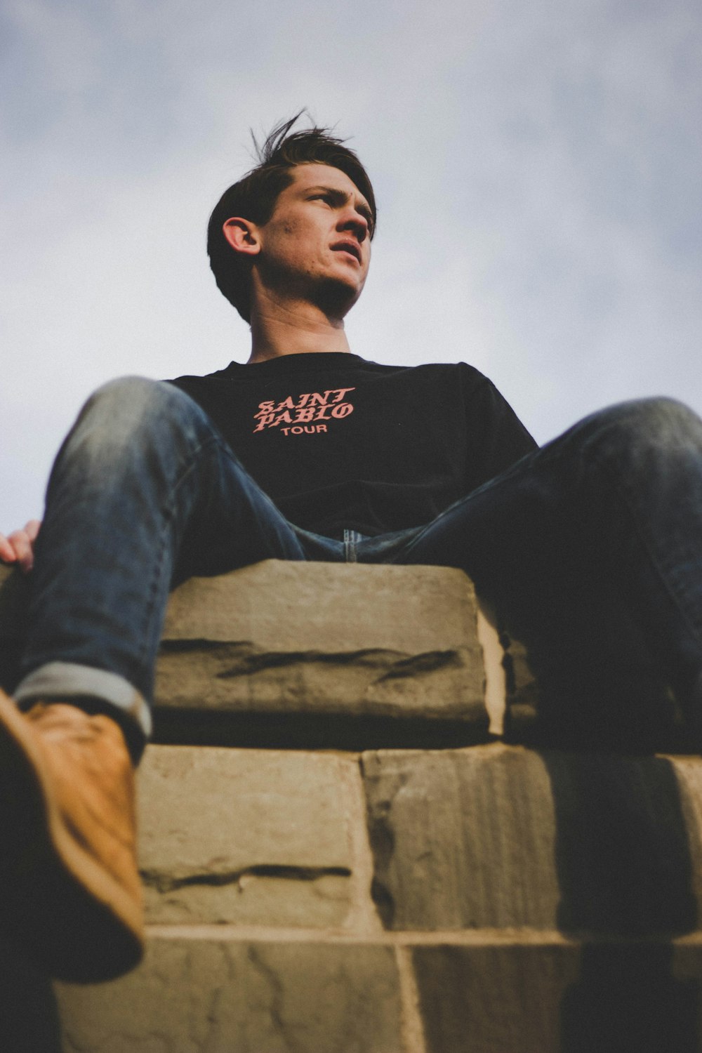 man sitting on gray surface