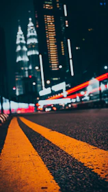 yellow pedestrian lane in road near concrete building during nighttime