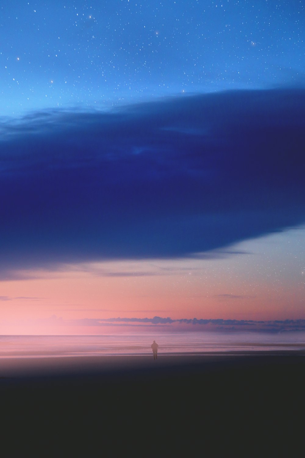 man standing on beach during sunset