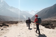 people hiking towards mountain ranges