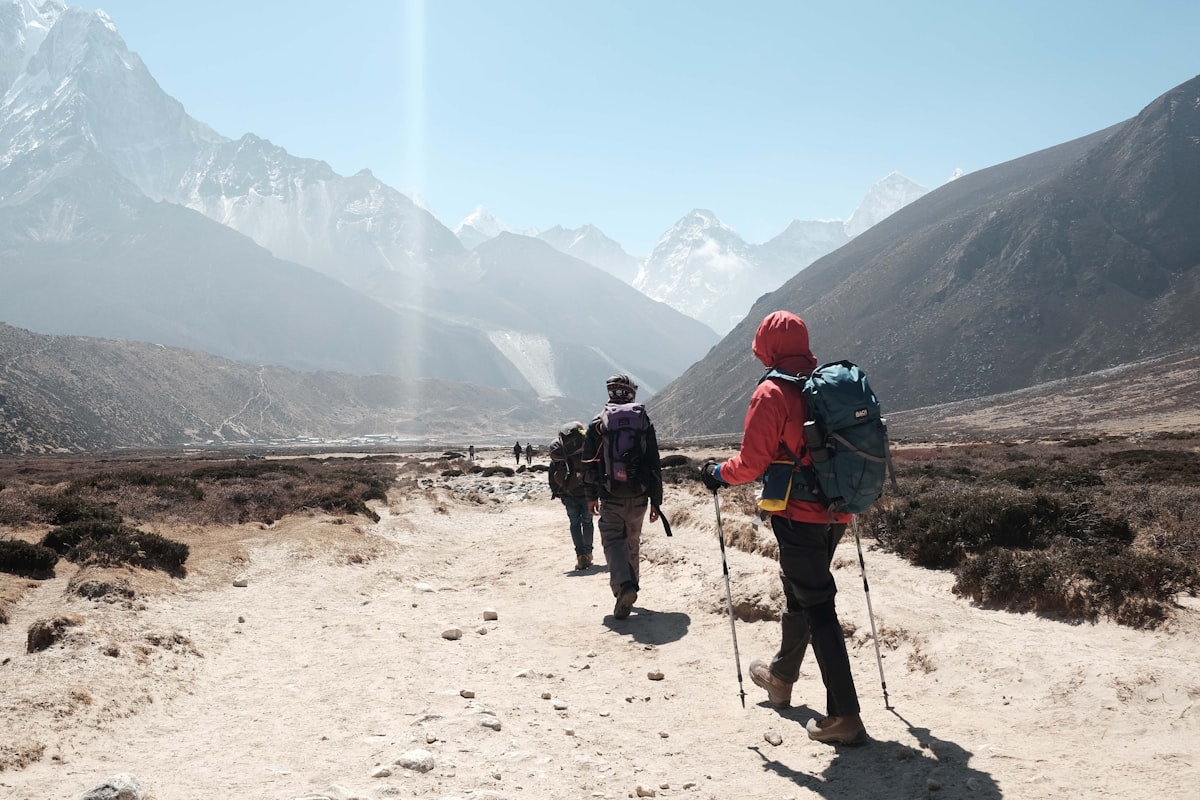 Trekkers hiking toward Himalayan peaks on the Everest Base Camp trail in Nepal