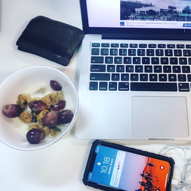 A warm, inviting workspace with a laptop open to a WhatsApp chat screen, surrounded by bowls of colorful cereals.
