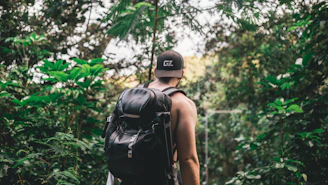 A traveler walking along a dense Indonesian jungle path with a backpack, symbolizing an adventurous journey across the archipelago.