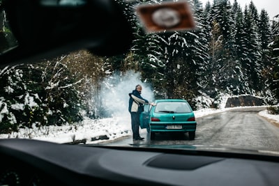 man standing in front of teal vehicle hatchback bosnia and herzegovina google meet background