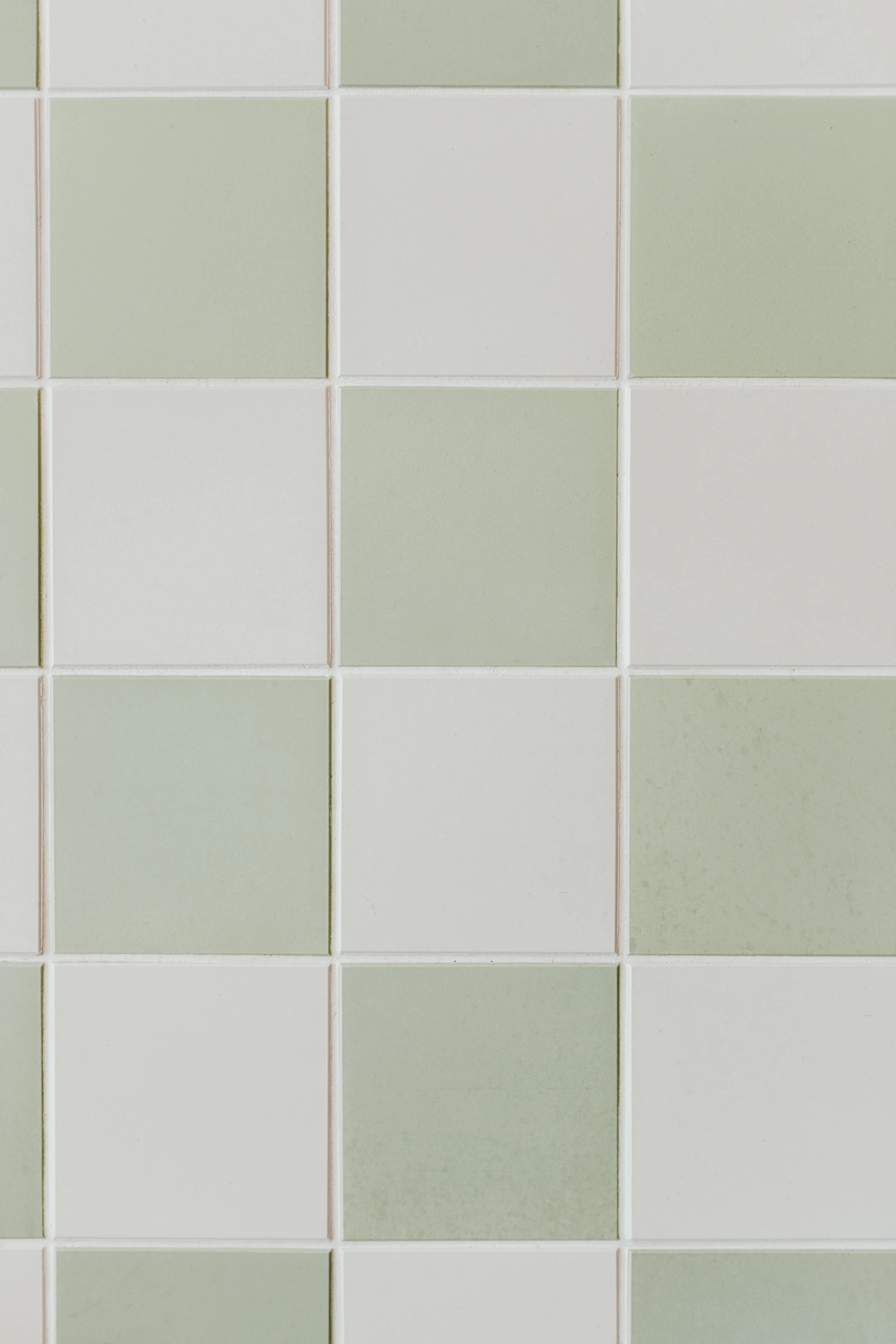 A close-up of gray and white square floor tiles