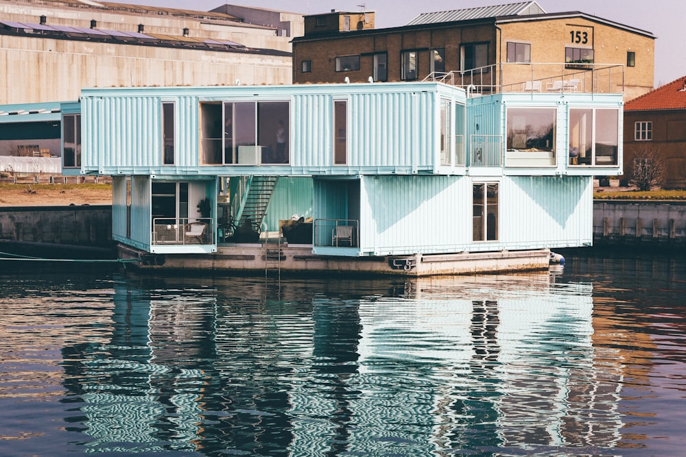 white wooden house near body of water at daytime