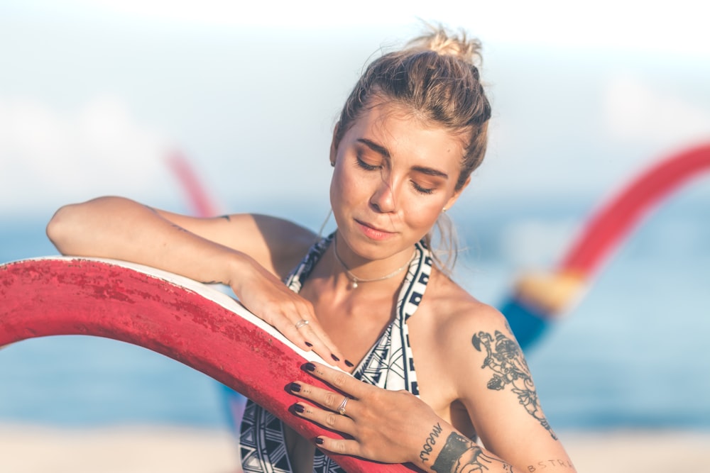 woman posing wearing halter top swimsuit during daytime