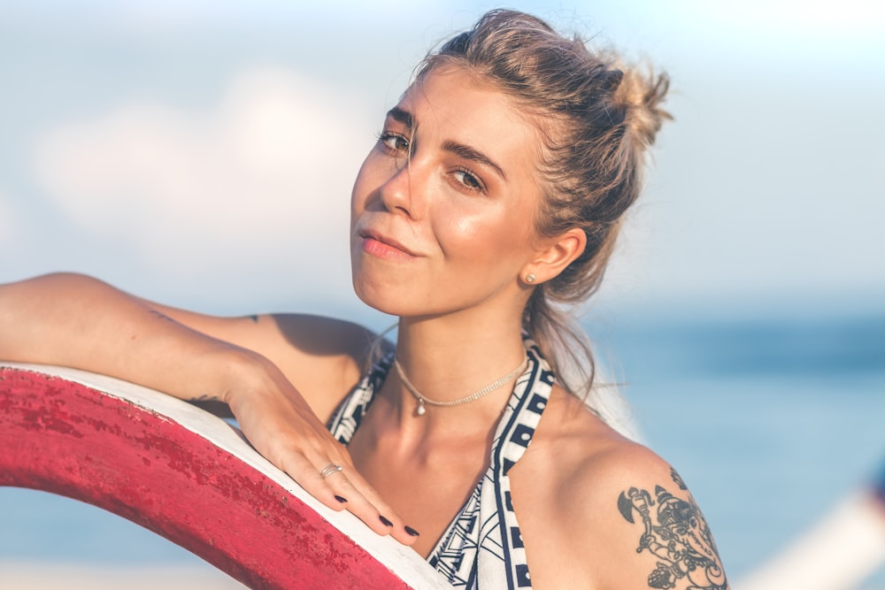 smiling woman in white and black halter top