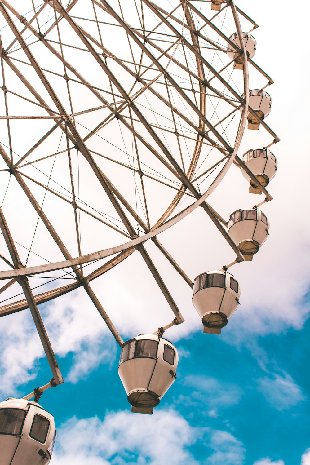 wormseye view of ferriswheel under blue sky