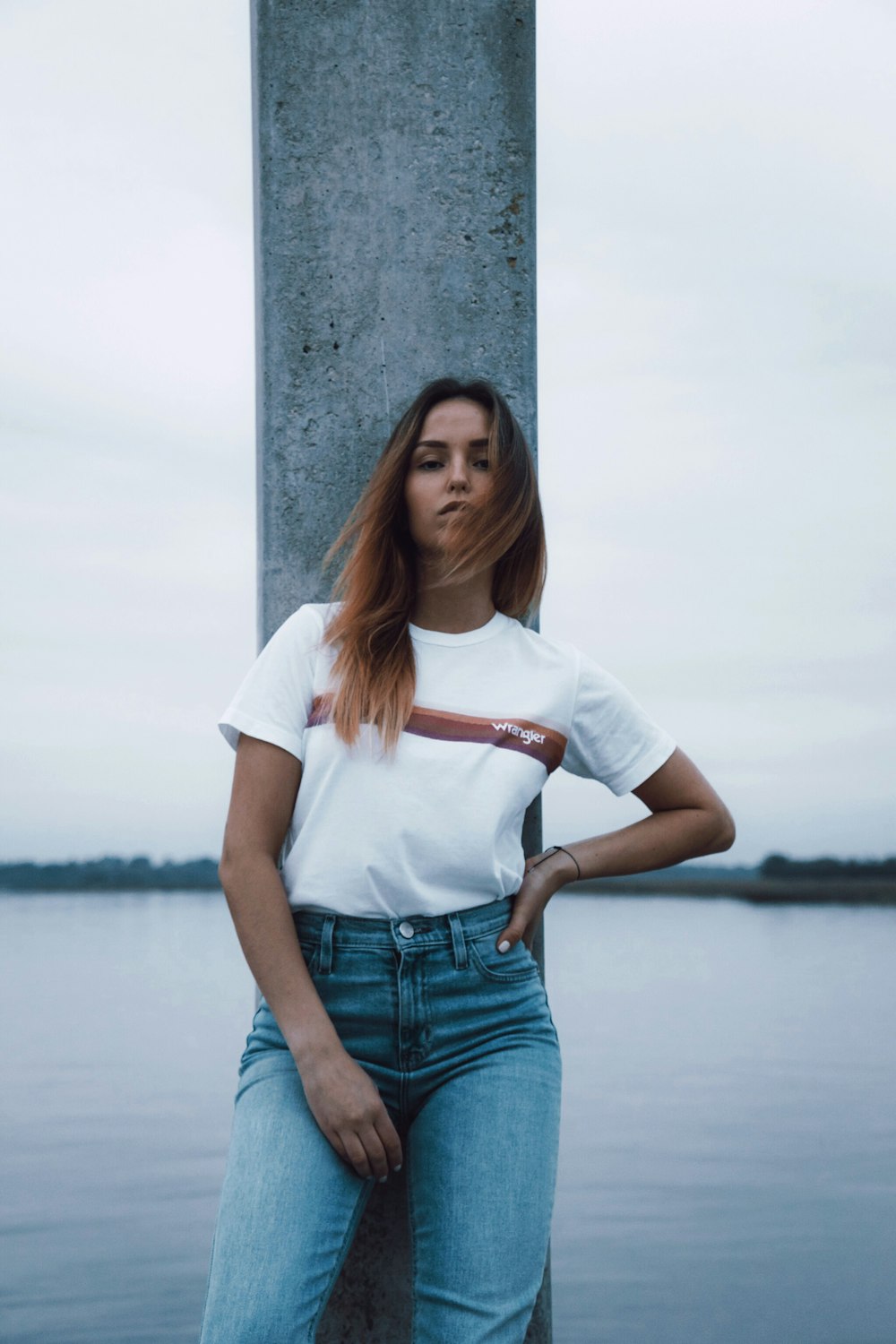 woman leaning on concrete pole posing for picture