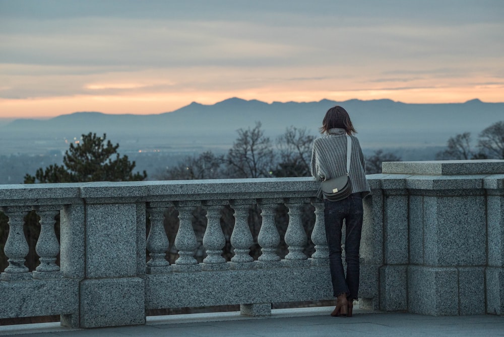 woman leaning on concrete rails