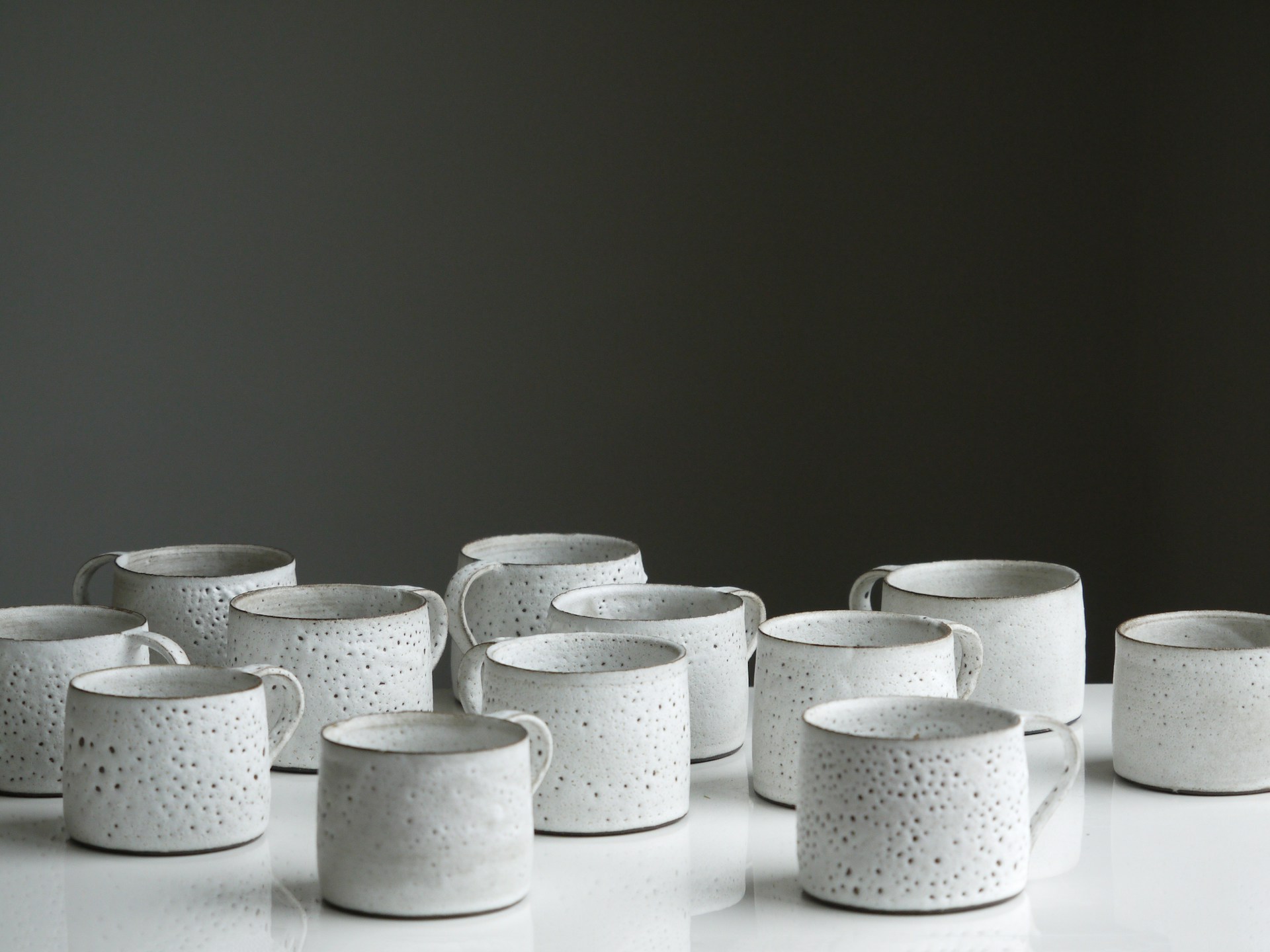 white ceramic mug lot on white surface