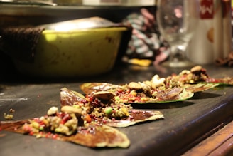 Close-up of a variety of plant-based snacks and treats with natural green leaves in the background.