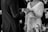 grayscale photo of man insert ring into woman during wedding ceremony