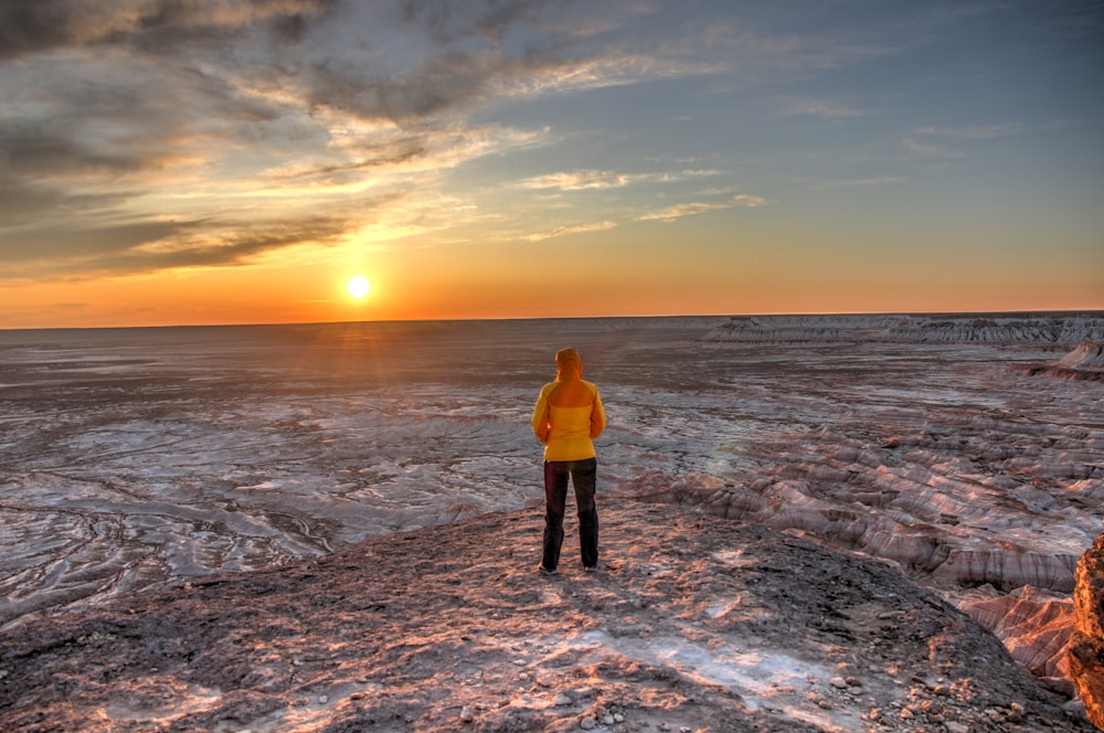 woman standing on brown cliff