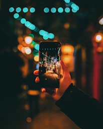 person taking photo of street