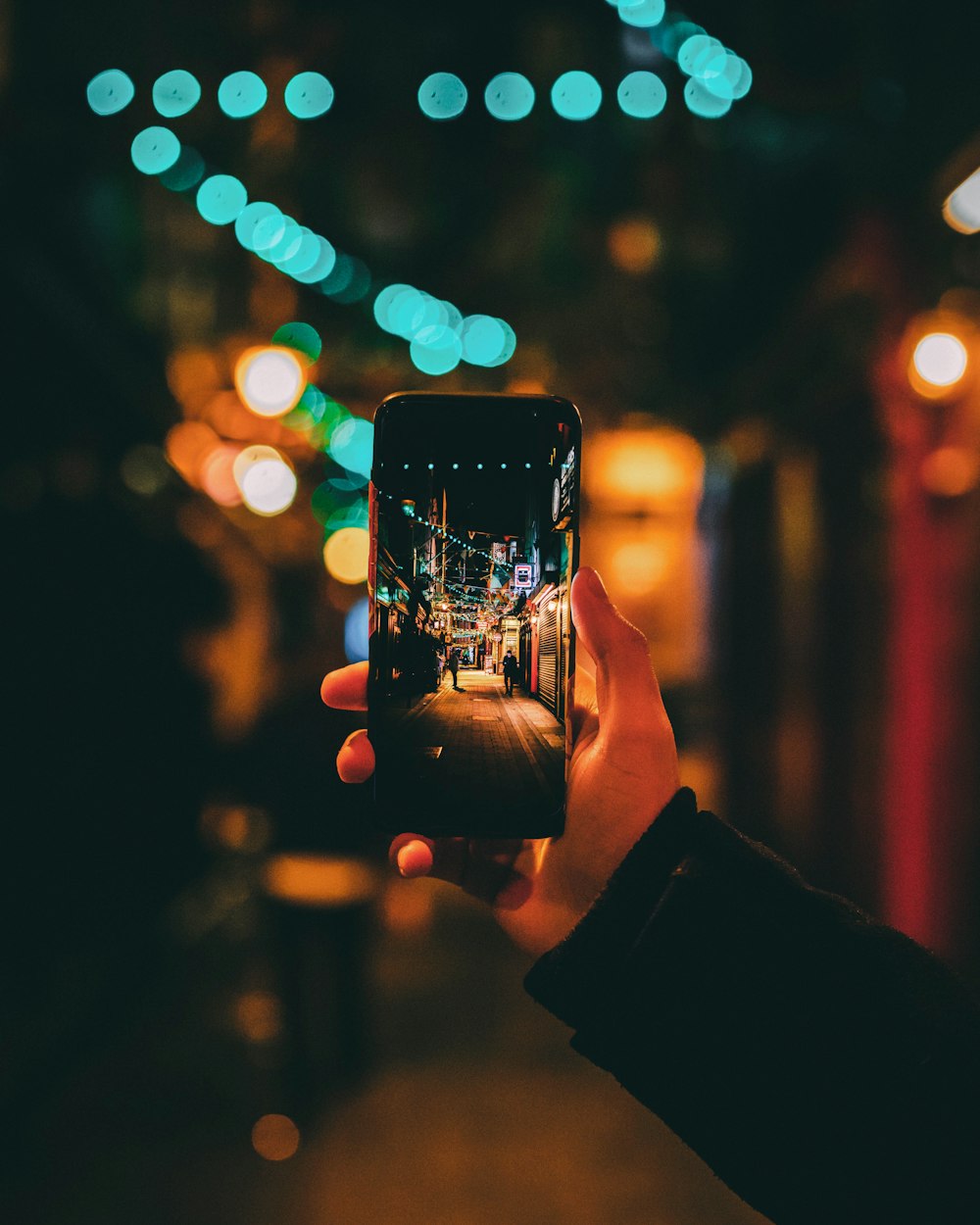 person taking photo of street