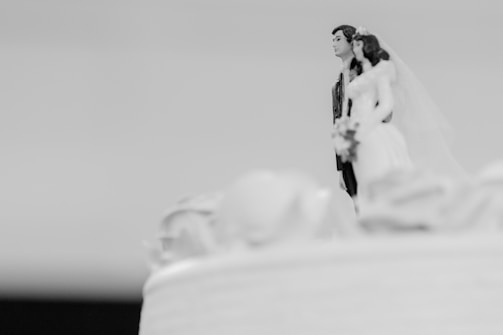 An intricately designed 3D-printed figurine used as a cake topper at a wedding.