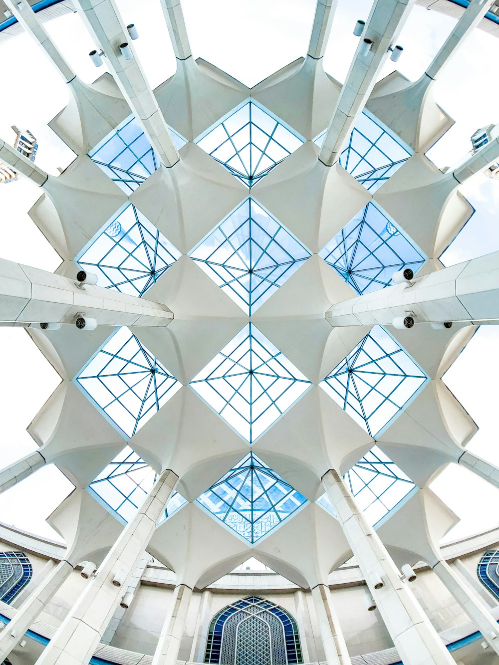 the ceiling of a large building with many windows