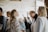 A cozy event space with soft lighting, filled with people enjoying a social gathering.